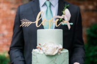 The groom was wearing a dark grey suit with a mint tie to match the color scheme