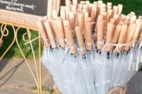 11 basket of clear umbrellas for wedding guests