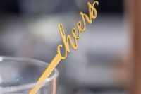 11 gold cheers stirrers are cute details to incorporate