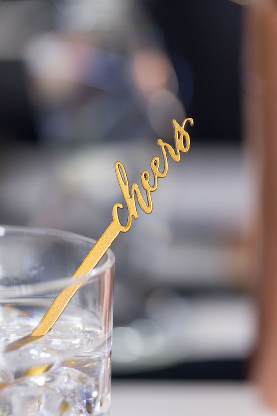 gold cheers stirrers are cute details to incorporate