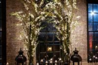 11 indoor branches and flowers arch with lots of candle lanterns