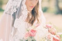 12 half updo with a mantilla veil for a heavenly look