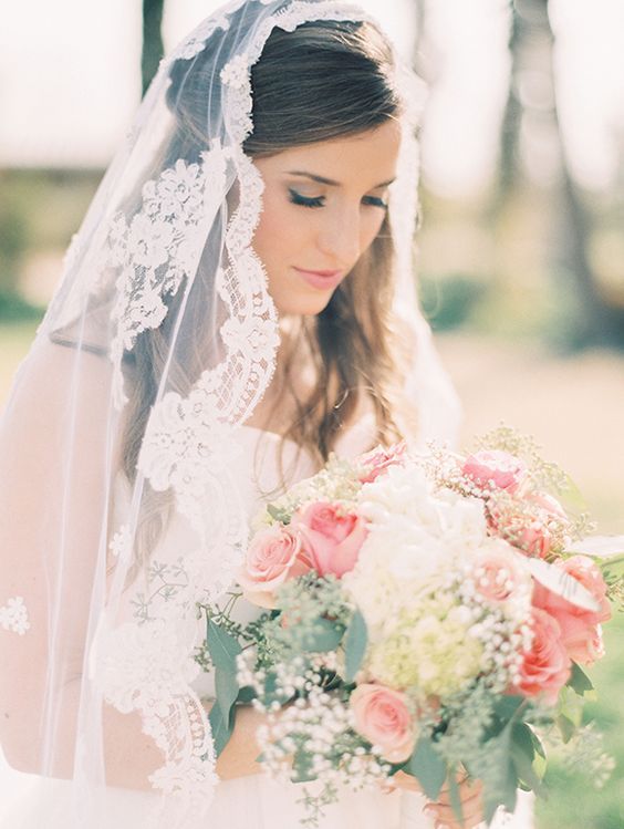 half updo with a mantilla veil for a heavenly look