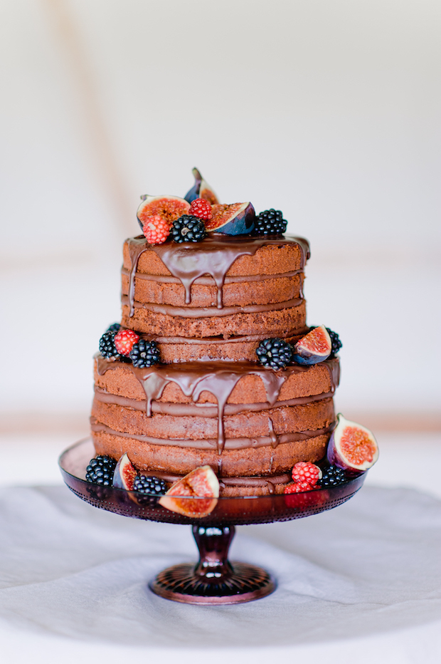 A gorgeous chocolate naked wedding cake with figs and black berries