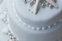 14 beach cake with a star fish and pearls in light blue