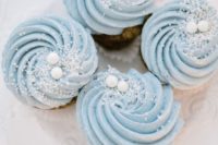 15 frosty blue wedding cupcakes with pearls on top