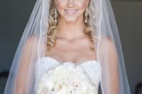 25 curly half updo with a white cathedral veil