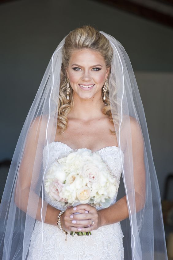curly half updo with a white cathedral veil