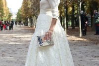 a feminine bridal shower outfit with a lace midi skirt, a white sweater and heels plus a box clutch is chic