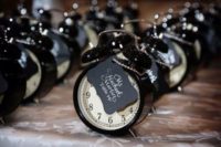 28 seating cards attached to cool little clocks as favors