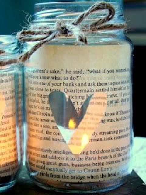 mason jars wrapped with book pages and with cutout hearts are amazing lanterns