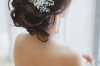 30 a messy updo with a rhinestone and bead hairpiece