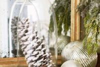 31 frosted pinecones under a cloche will bring a cozy touch to your decor