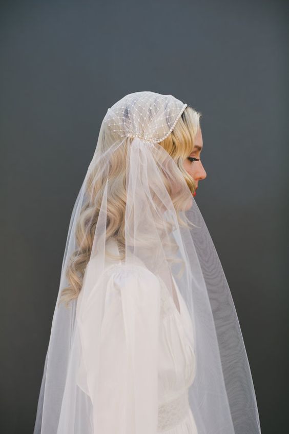 long curls down with a beaded juliet cap veil of tulle