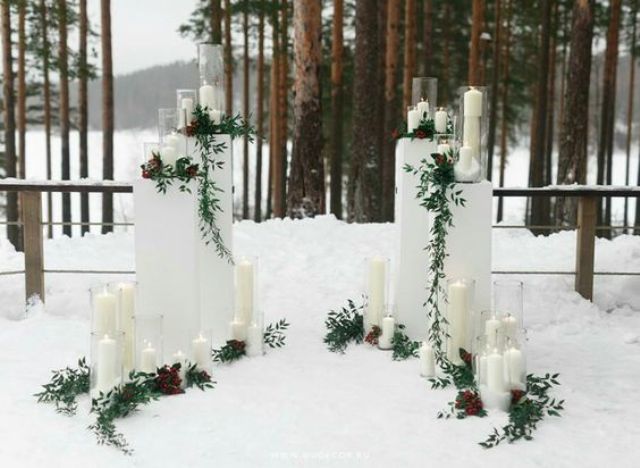 outdoor winter altar with candles and greenery that shows up the scenery