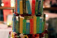 32 book spines wedding cake topped with flowers