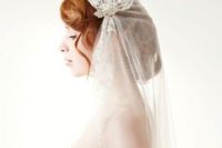 33 curled updo with a juliet cap lace veil with bead hair combs