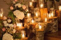 35 wood logs as candle stands give coziness to your wedding
