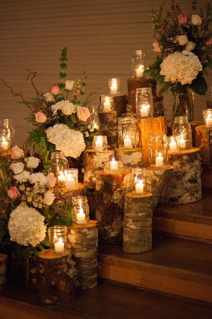 wood logs as candle stands give coziness to your wedding