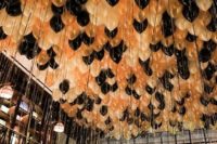 38 ceiling decorated with cream, gold and black balloons