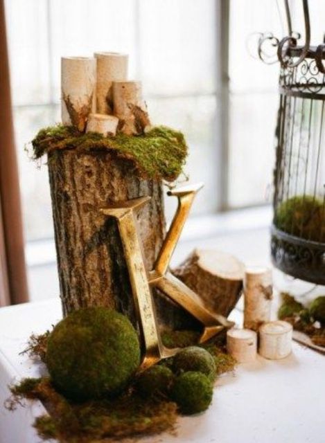 moss and moss balls with wood logs and candles for decor