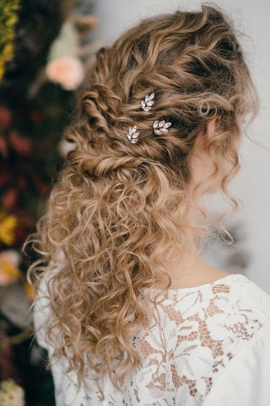a beautiful and chic curly half updo with a curly top and twists, curls down and rhinestone hair pins is amazing