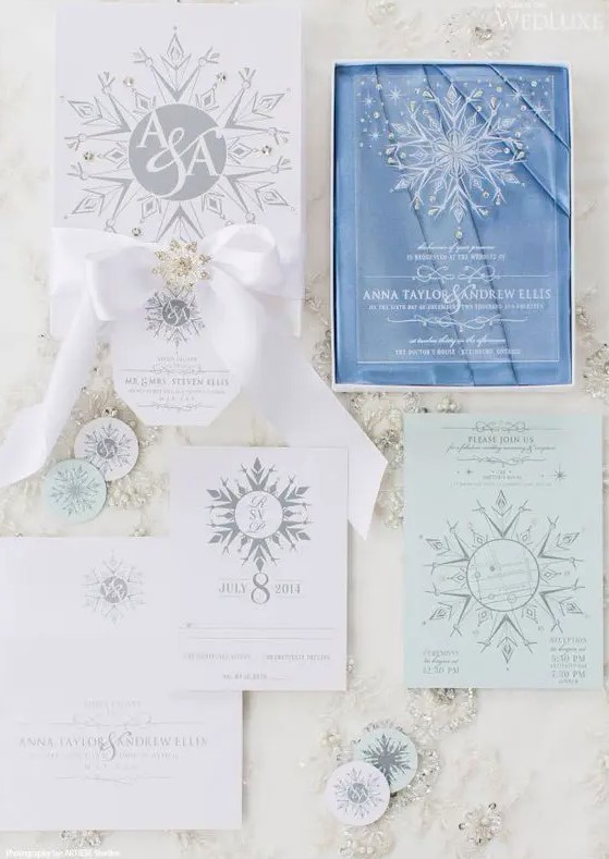 a beautiful snowflake wedding invitation suite with paper and clear acrylic pieces, printed and 3D snowflakes with rhinestones