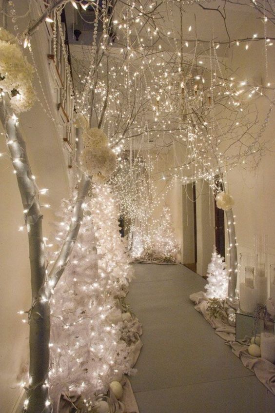 a beautiful winter wonderland space with white Christmas trees and lights, crystals and rhinestones, candles and blooms is wow