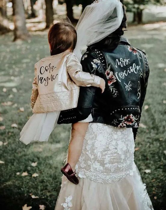 a black studded leather jacket with additional floral painting is a great idea for a fall or winter bridal look, it wows
