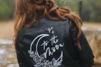 a boho bridal look finished off with a black leather jacket with white calligraphy and images is a great idea for a wedding