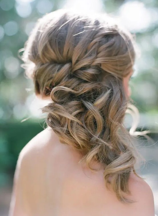 a braided side-swept medium hairstyle with curly tips is a cool and chic idea with a slight romantic touch