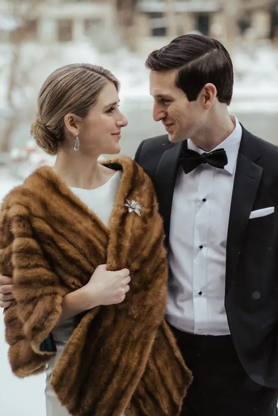 a brown faux fur stole with an embellished floral brooch to finish off the winter vintage-inspired bridal look