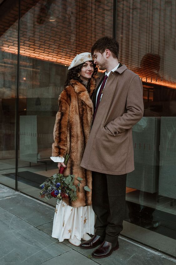 a brown midi faux fur coat is a lovely addition to the bridal look, and it will keep her warm anytime