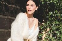 a creamy chunky knit cardigan with no buttons but with a polished gold belt for a modern and romantic bridal look