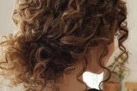 a curly messy low bun with bangs is a timeless idea for girls with curls – looks very pretty and relaxed