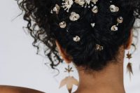 a curly wedding updo with lots of rhinestone hair pins to accent it and curls on top is amazing