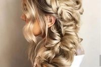 a dimensional and loose side braid with a halo and some face-framing waves is a stylish and catchy idea