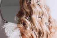 a dreamy celestial wedding hairstyle with waves down and some rhinestone hairpieces is a lovely idea for a celestial wedding