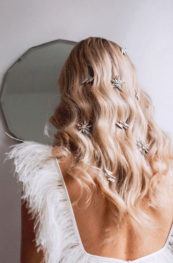 a dreamy celestial wedding hairstyle with waves down and some rhinestone hairpieces is a lovely idea for a celestial wedding