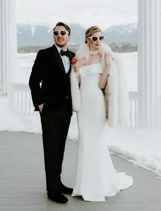 a glam bridal look with a catchy off the shoulder mermaid wedding dress, a pearl necklace, a white faux fur jacket for a winter wedding