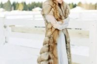 a gorgeous long faux fur sleeveless coat is a stunning accessory for a snowy winter wedding to feel a real ice queen