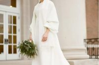 a gorgeous oversized super long coat with puff sleeve and train is ideal for a modern or minimalist bride to make a statement