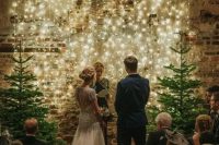 a light wall plus a duo of non-decorated Christmas trees are all you need to create a festive ambience and make the space inviting