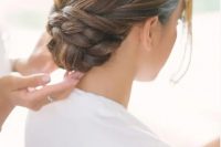 a low twisted and braided bun with a sleek top looks very elegant and chic, and face-framing hair is a great solution