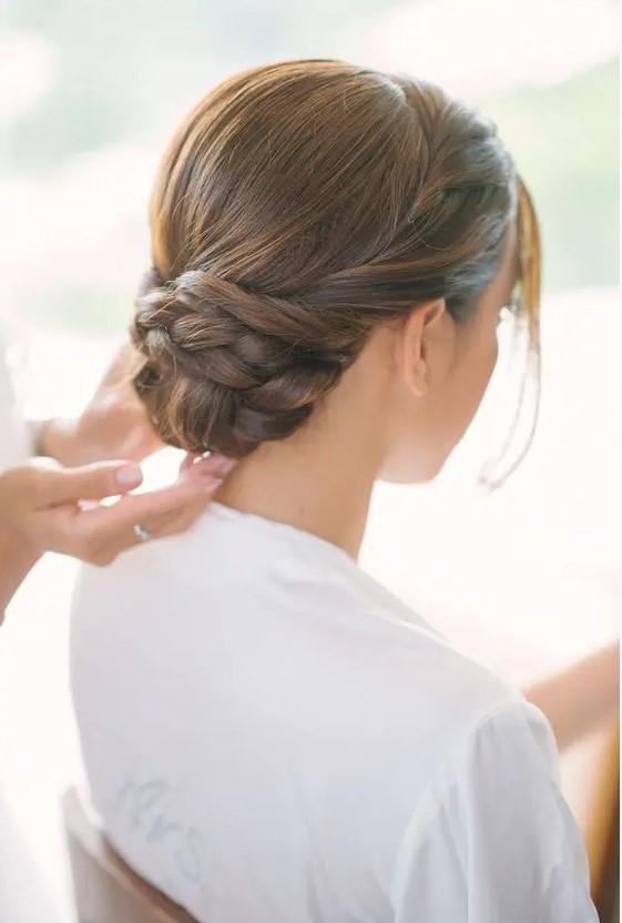 a low twisted and braided bun with a sleek top looks very elegant and chic, and face-framing hair is a great solution