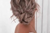 a messy and wavy low bun with a wavy top, some face-framing locks and a twisted low bun is cool and catchy