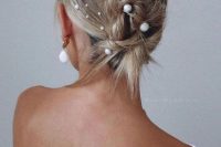 a messy twisted updo on medium-length hair with multiple pearl hair pins is a cool solution if your hair isn’t long enough