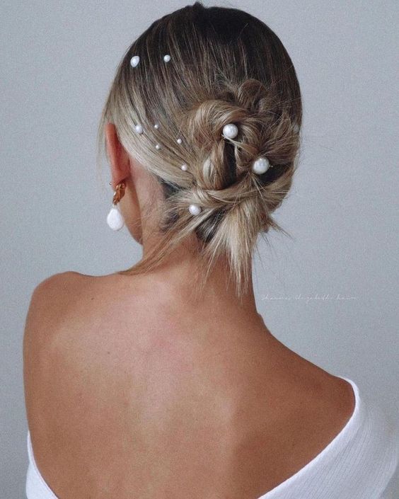 a messy twisted updo on medium-length hair with multiple pearl hair pins is a cool solution if your hair isn't long enough