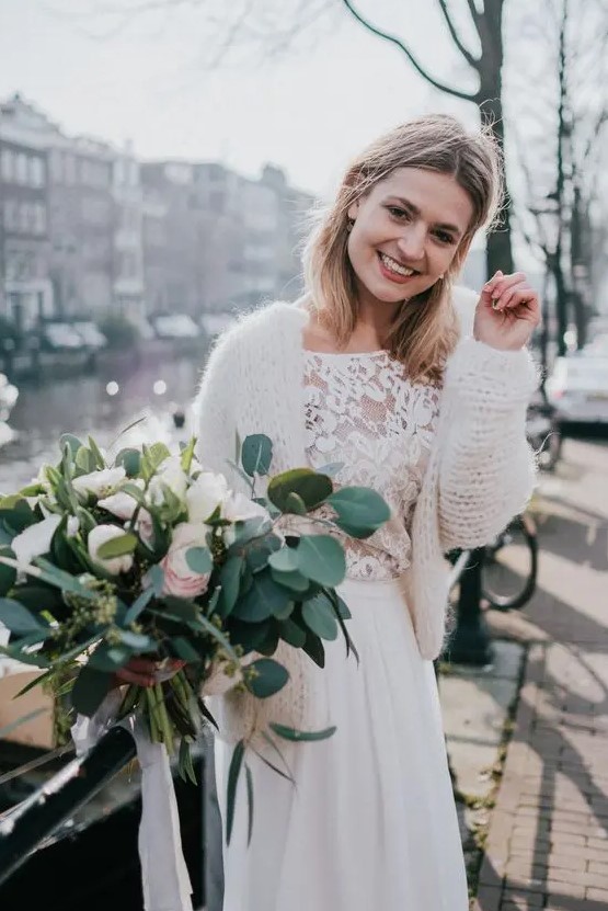 a modern bridal outfit with a boho lace top, a plain pleated skirt, a chunky knit cardigan to keep your warm