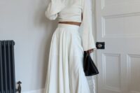 a modern bridal shower look with a pleated midi skirt, a crop top with bell sleeves, black shoes and a black bag